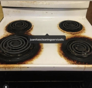 A very dirty stove top with burnt residue before professional cleaning by Juanita's Cleaning Services LLC in Gulfport, MS.