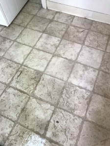 A dirty tiled floor before professional cleaning by Sharp & Clean in Idaho Falls, ID.