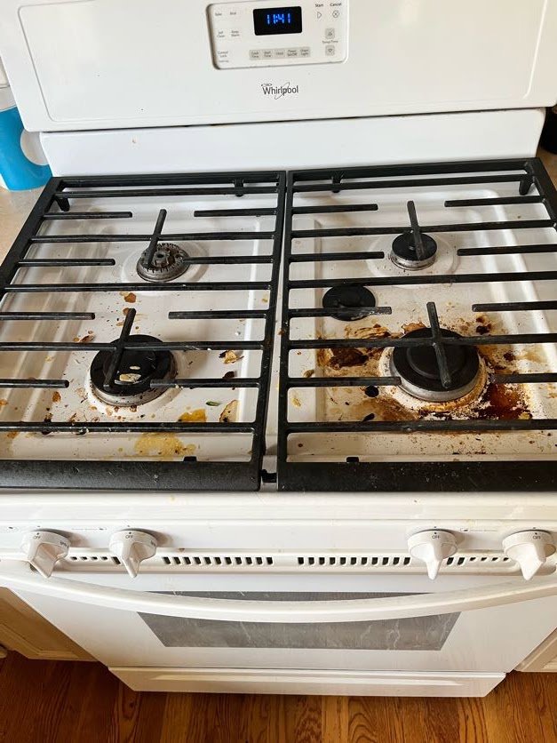 A dirty tiled shower with visible grime and soap scum before cleaning by Sage & Soap Cleaning Co in Kansas City, MO.