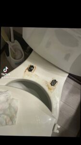 A dirty toilet with visible rust stains, illustrating a 'before' cleaning scenario for Cleaning Sisters LLC in Richmond, VA.