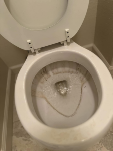 A dirty toilet bowl before professional house cleaning by A.M.L Janitorial Services LLC in Sparks, NV.