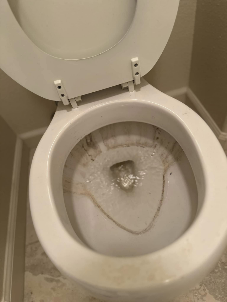 A dirty toilet bowl before professional house cleaning by A.M.L Janitorial Services LLC in Sparks, NV.