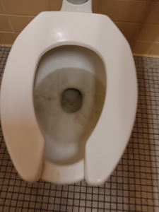 A dirty toilet bowl before cleaning, demonstrating the need for services from Janice Janitorial LLC in Baton Rouge, LA.