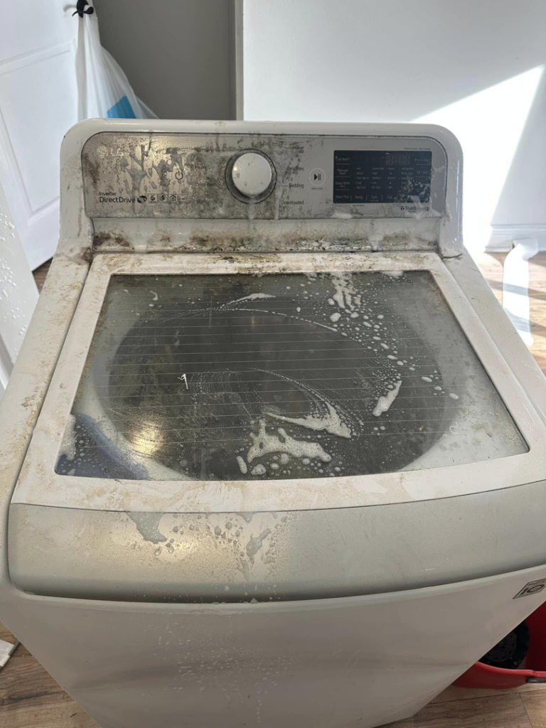 A very dirty washing machine covered in grime and soap, before cleaning by Sarah's Cleaning Services in Kenner, LA.