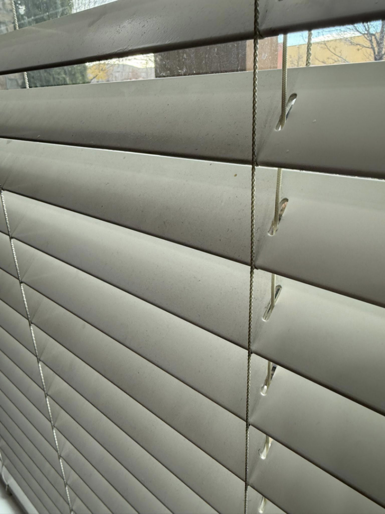 Dirty window blinds in a home, ready for cleaning by Caro's Pro Cleaning Services in Orem, UT.