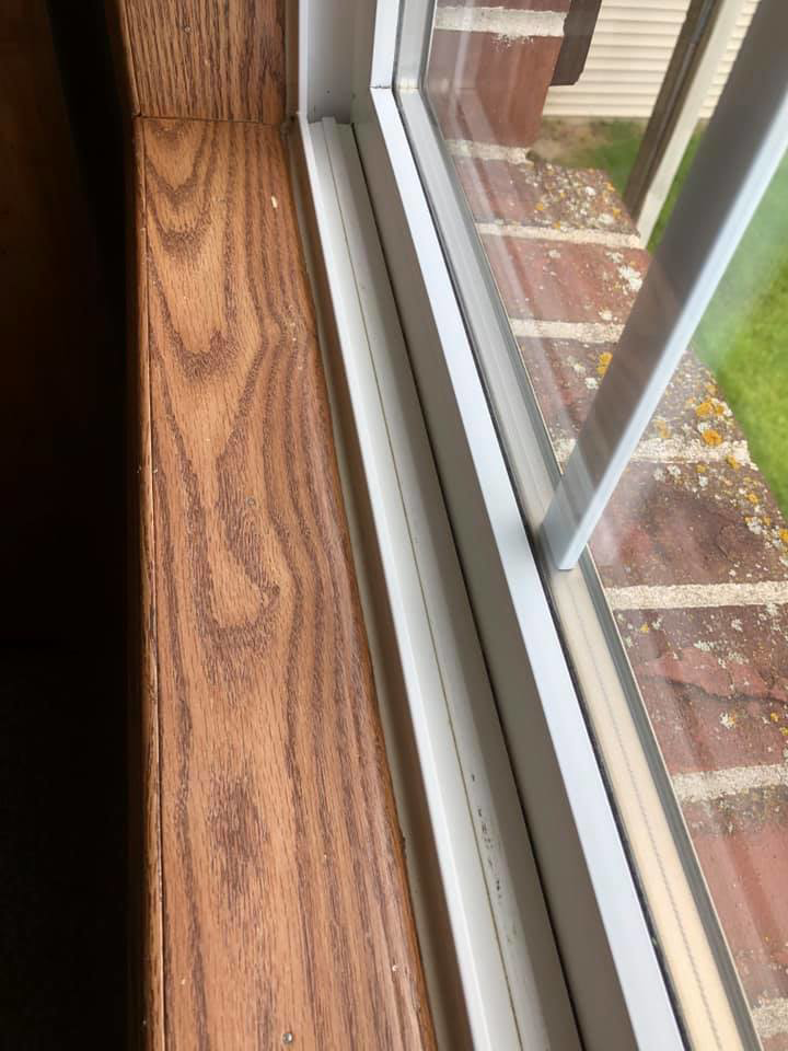 A dirty window sill and frame showing dust and debris before cleaning by RA Cleaning Services in Brockton, MA.