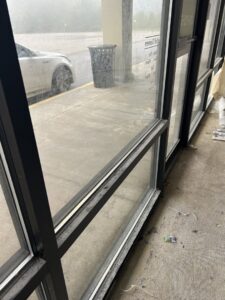 Dirty windows and floor in a commercial or residential space before cleaning by Perfections Quality Cleaning Service in Dayton, OH.