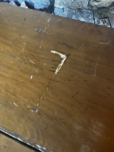 A very dirty wooden table surface before professional cleaning by Clean & Clear Pros LLC in Timm Place, USA.