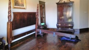 A disassembled wooden bed frame and wardrobe, indicating moving services by Ang Moving Co in Dallas, TX