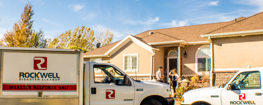 Rockwell Disaster Cleanup trucks parked outside a residential home, ready to assist with water damage in West Valley City, UT.