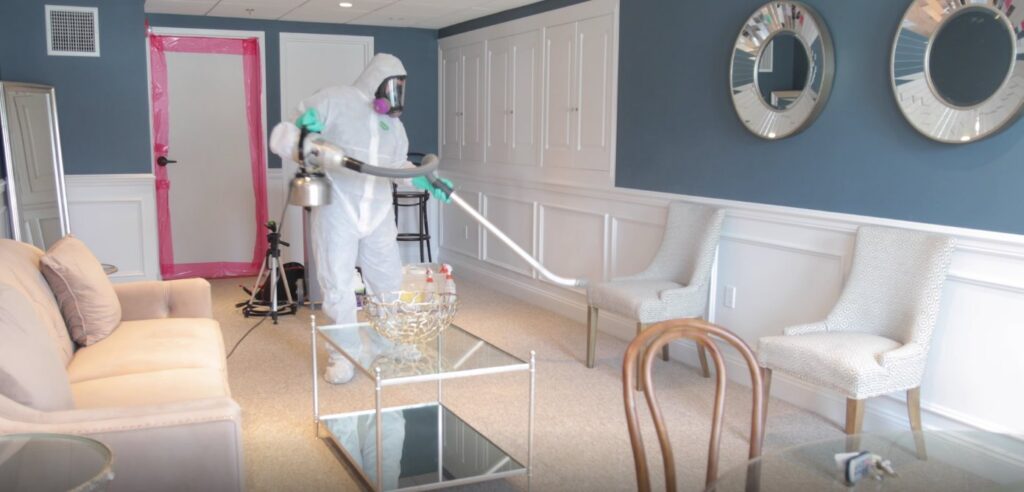 A Green Home Solutions technician performing disinfection fogging after water damage in a living room in Mount Airy, MD.