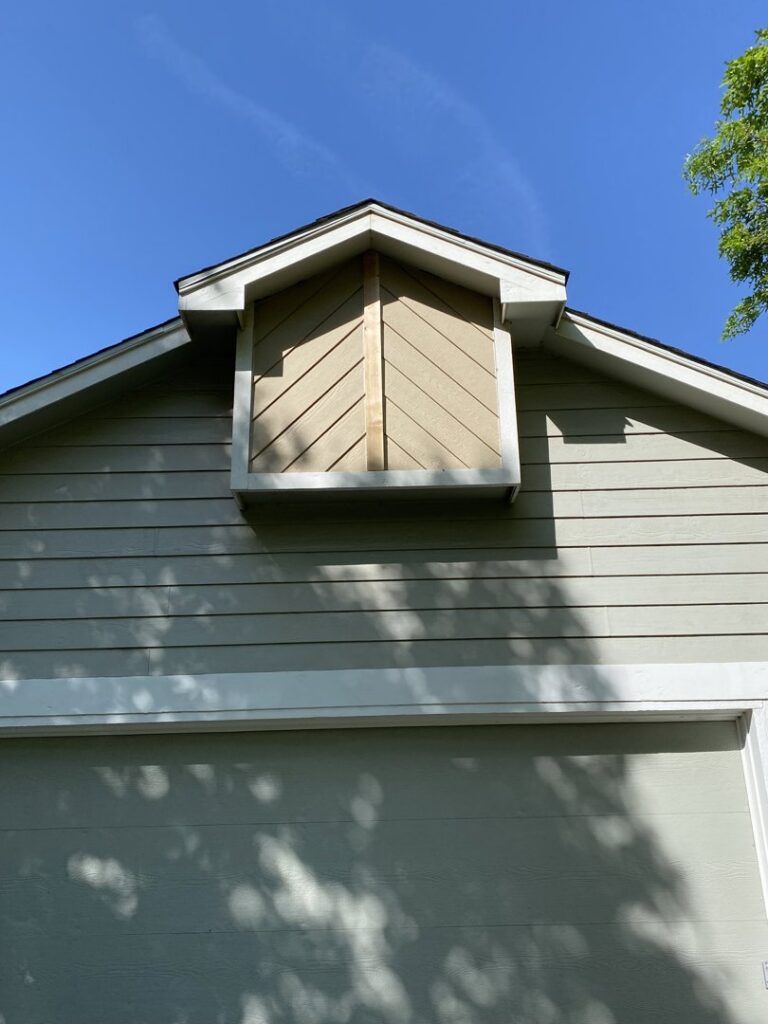 Detailed view of new siding installed on a dormer by River City Exteriors in San Antonio, TX