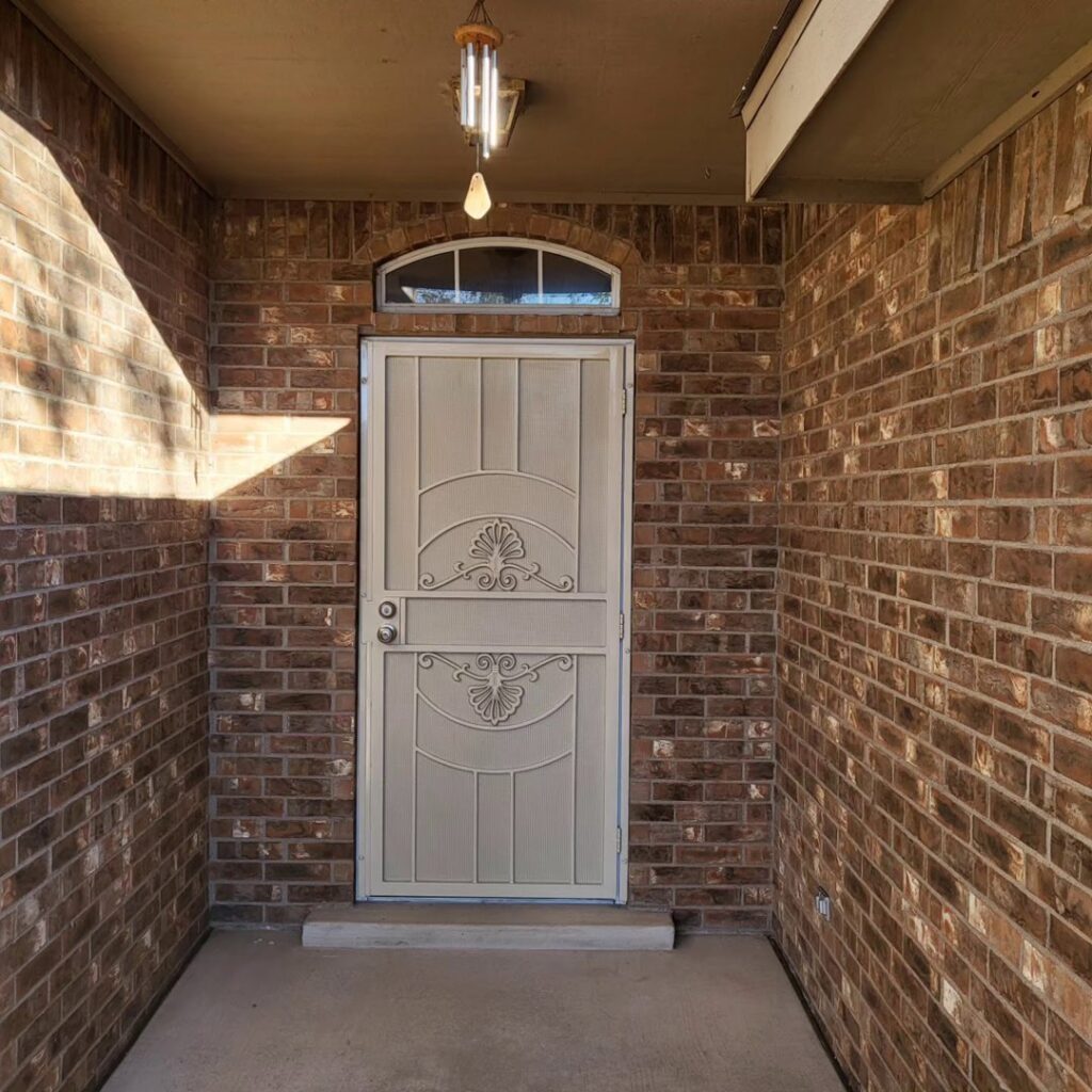 Two newly installed beige panel garage doors by Spartan Garage Doors and More in Albuquerque, NM.