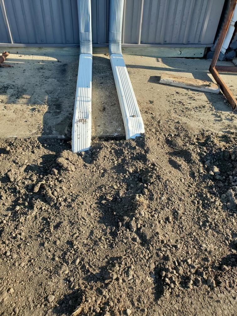 Underground downspout drainage system installed to prevent water damage by KD Services - Excavating in Bismarck, ND