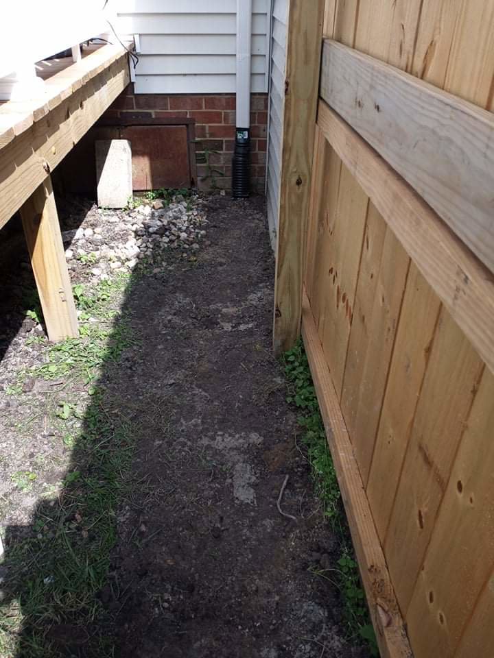 A downspout extension directing water away from a home's foundation by Tidewater Home Improvement LLC in Hampton, VA.