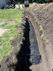 Large corrugated drainage pipe being installed in a trench by KD Services - Excavating in Bismarck, ND