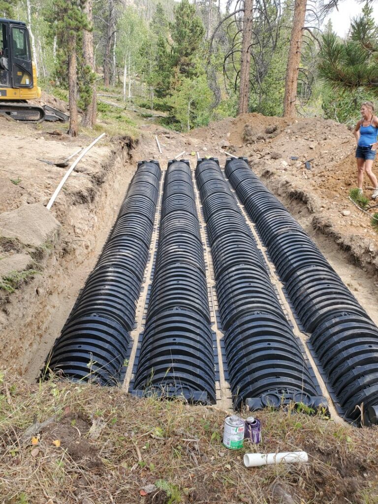 Installation of a new drainage system with black corrugated pipes by Chambers Excavating in Casper, WY