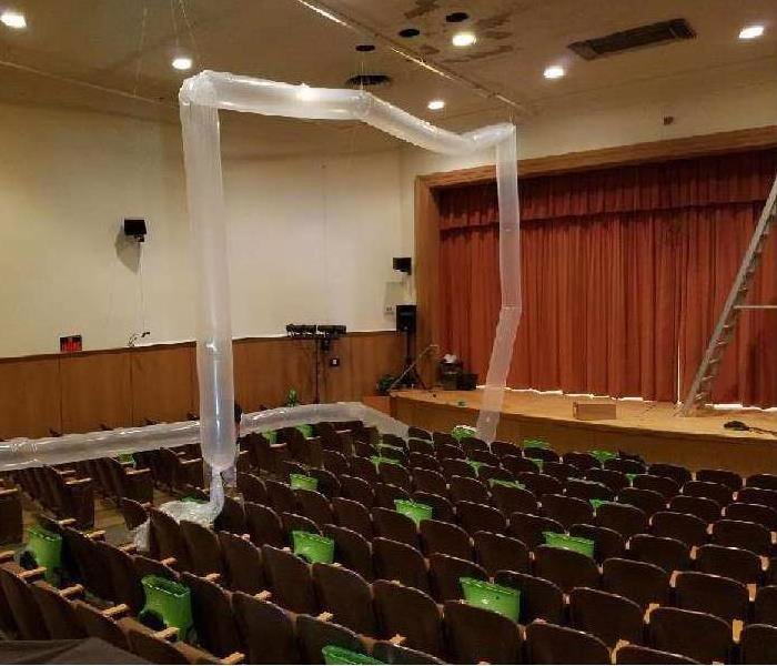 Large drying equipment and ducts set up in an auditorium by SERVPRO of Brandywine/Wilmington for water damage restoration in Wilmington, DE.