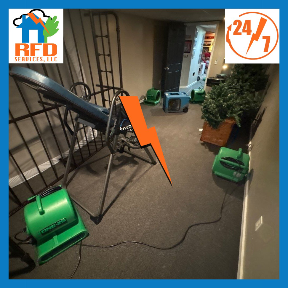 Drying equipment, including air movers and a dehumidifier, set up in a room after water damage by RFD Services in Akron, OH.