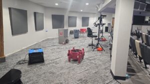 Drying equipment and air movers set up in a large room for water damage restoration by TriForce Restoration in Moore, OK.