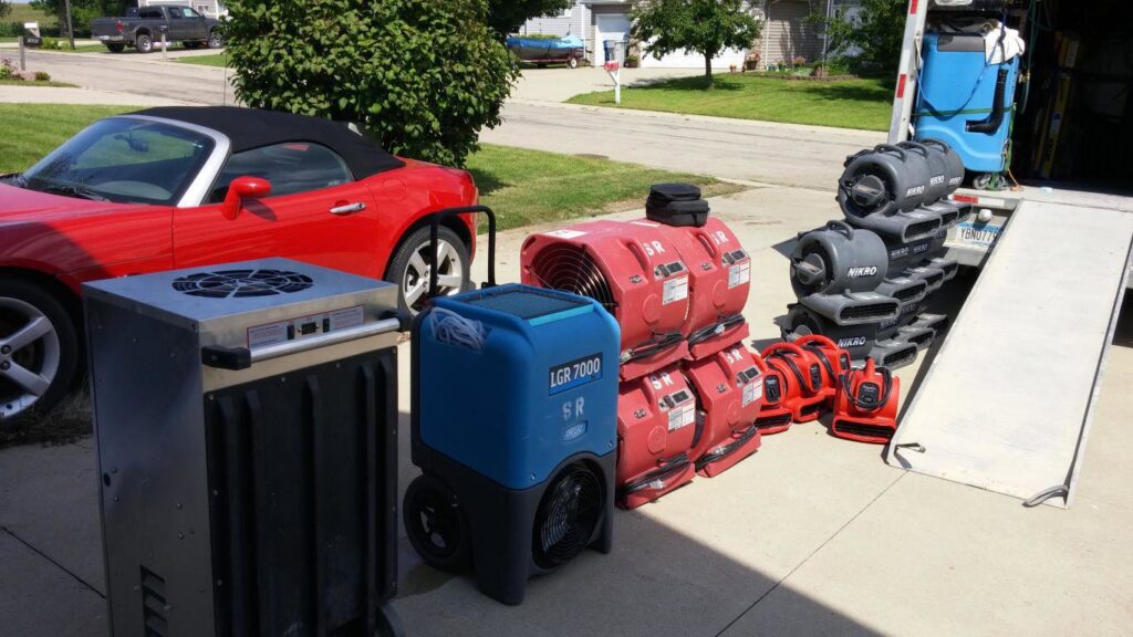 Professional drying and dehumidification equipment being unloaded for a water damage job by Water Damage Pro in Minneapolis, MN