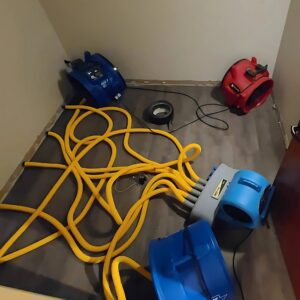 Multiple air movers and drying equipment set up in a room for water damage restoration by Superior Contract Cleaning in Lafayette, LA.