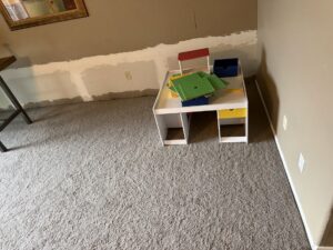 Drywall removed from the lower walls of a room, a step in water damage remediation by Flow State Restoration in Gilbert, AZ