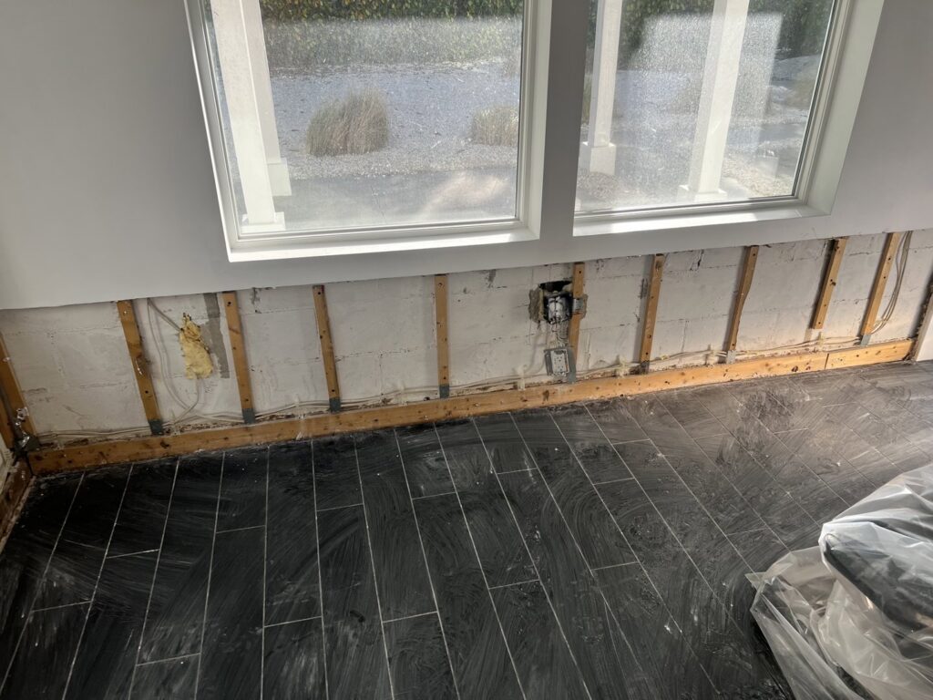 Drywall removed to expose studs for water damage repair by Minutemen Property Damage Services in North Charleston, SC.