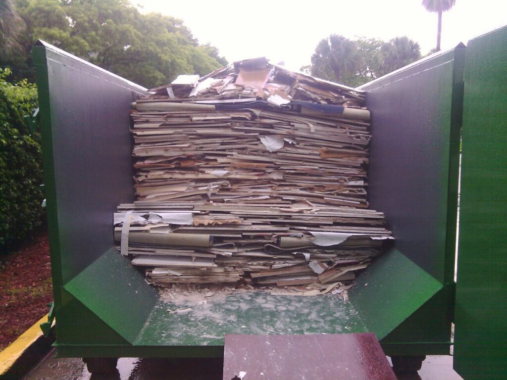 A large dumpster filled with demolition debris, handled by Dade Wrecking Demolition LLC in Miami, FL.