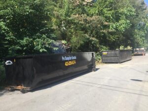 Two dumpsters placed at a demolition site for debris removal by Pro Dumpster Rentals in Chattanooga, TN.