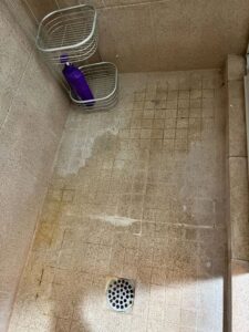 A dusty TV and media console before professional cleaning services from Sage & Soap Cleaning Co in Kansas City, MO.