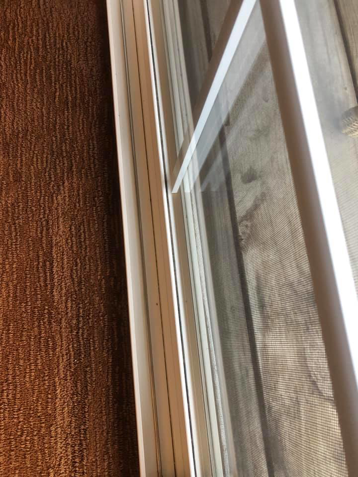 A dusty window frame and screen indicating an area needing cleaning by RA Cleaning Services in Brockton, MA.