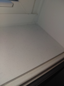 A dusty window sill showing the need for cleaning services from White Lotus Cleaning Services LLC in Nashua, NH.