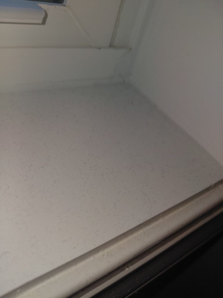 A dusty window sill showing the need for cleaning services from White Lotus Cleaning Services LLC in Nashua, NH.