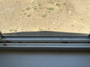 A dusty window track and sill, highlighting an area that needs professional cleaning from Blubyrd Cleaning Service in Boise, ID.