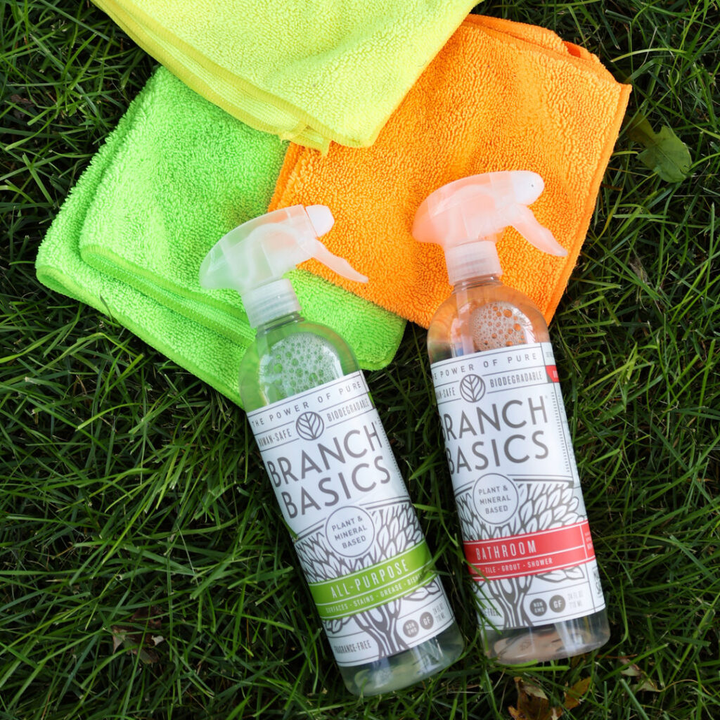 Eco-friendly Branch Basics cleaning sprays and microfiber cloths on grass, used by Natural Clean in Sioux Falls, SD.