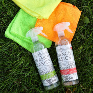Eco-friendly Branch Basics cleaning sprays and microfiber cloths on grass, used by Natural Clean in Sioux Falls, SD.