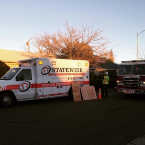 Statewide Restoration Inc. emergency response van and fire truck at a water damage restoration job site in North Little Rock, AR.