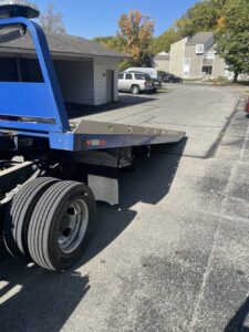 An empty blue flatbed tow truck from Mr.Quickpick Roadside Assistance, ready for towing services in Indianapolis, IN.