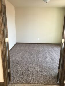 An empty, freshly cleaned carpeted room, perfect for a move-out clean by Pristine Cleaning Concepts in Stillwater, OK.