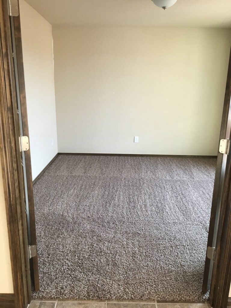 An empty, freshly cleaned carpeted room, perfect for a move-out clean by Pristine Cleaning Concepts in Stillwater, OK.