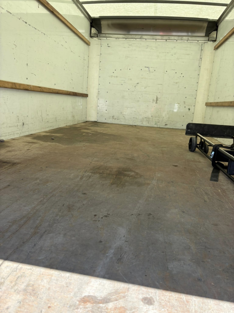 The clean, empty interior of a moving truck with a hand truck, ready for a job by Groovy Movers LLC in Batavia, NY.