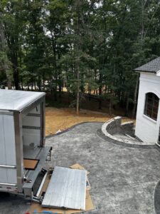 An empty moving truck with its ramp extended, parked next to a house, ready for a job by The Knoxville Moving Co. in Knoxville, TN.
