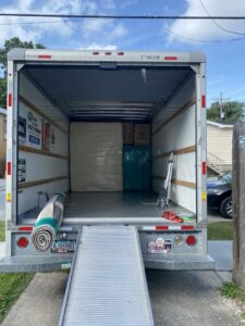 The back of an empty moving truck with a ramp extended, ready for loading by Reynolds Moving in Baton Rouge, LA