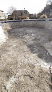 An empty pool with its interior surface prepared for renovation or replastering by J.R. Pools in Lubbock, TX.