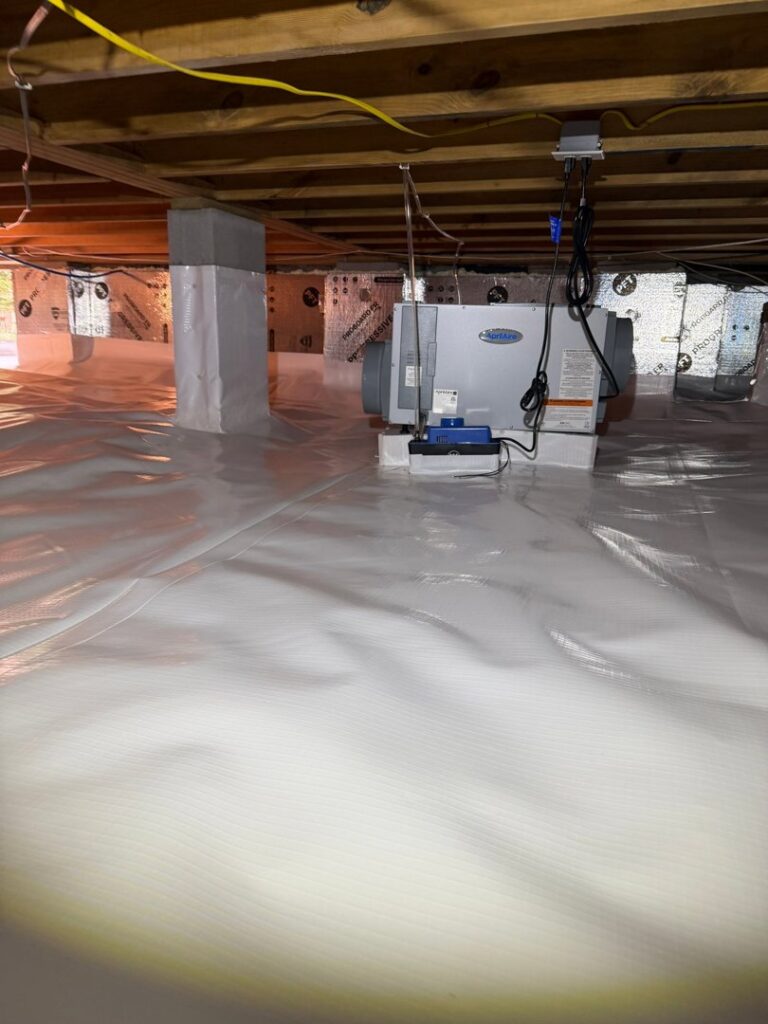 An encapsulated crawl space with a dehumidifier for moisture control by Wetlock Waterproofing in Rock Hill, SC.