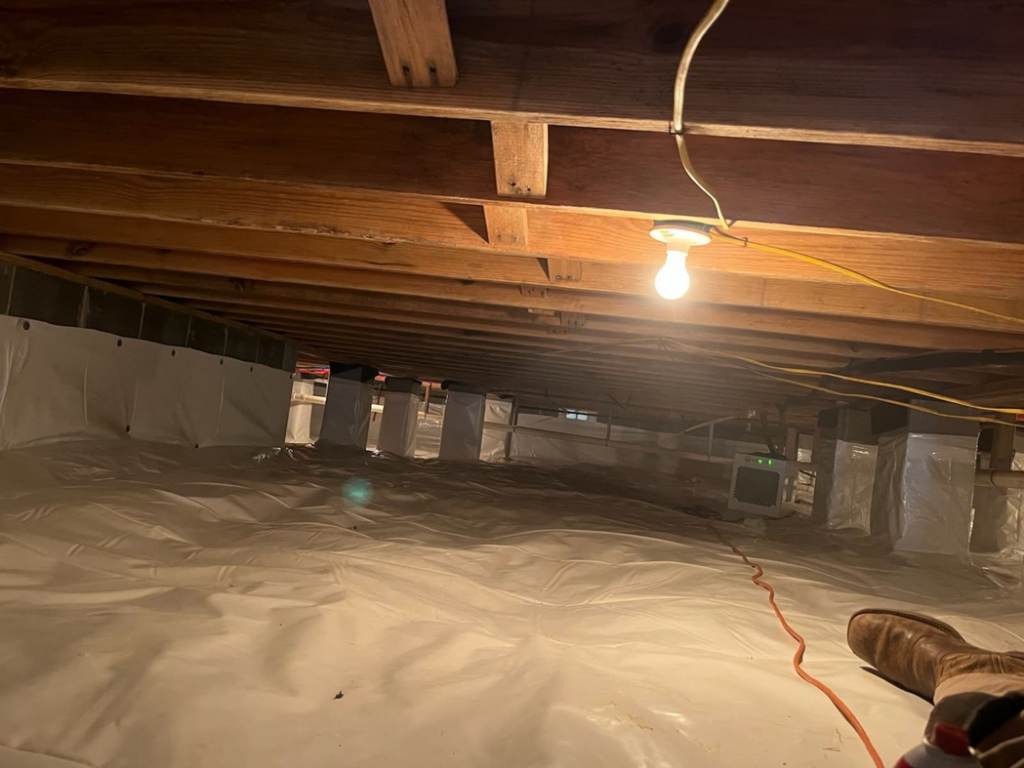 A clean, encapsulated crawlspace with a dehumidifier, preventing water damage by Allied Foundation & Crawlspace Solutions in Decatur, AL.