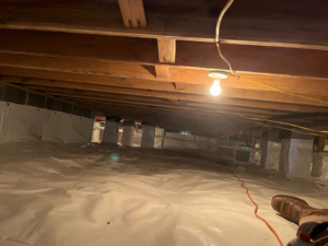 A clean, encapsulated crawlspace with a dehumidifier, preventing water damage by Allied Foundation & Crawlspace Solutions in Decatur, AL.
