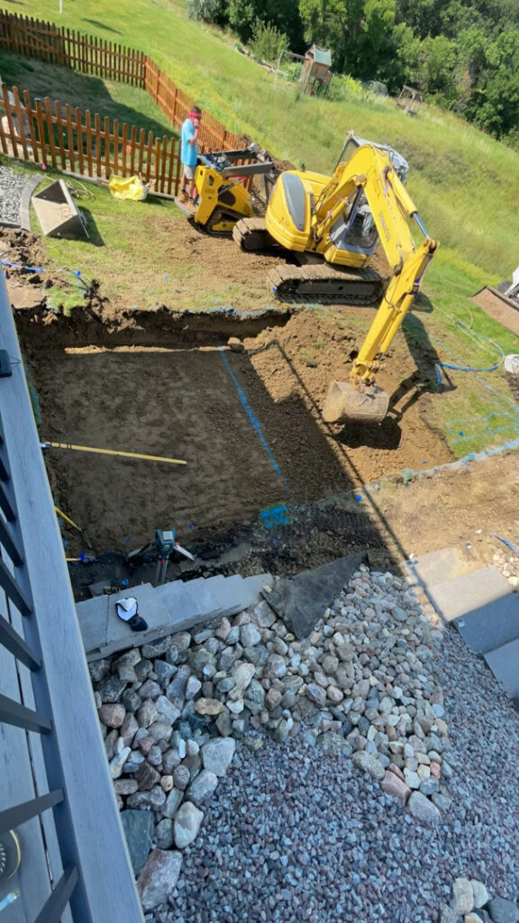 An excavated hole prepared for a new swimming pool installation by Backyard Escapes by Kerner Pools & Spas in Bismarck, ND.