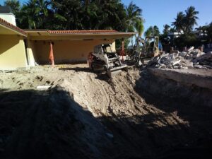 An excavation and demolition site with heavy machinery by Dade Wrecking Demolition LLC in Miami, FL.